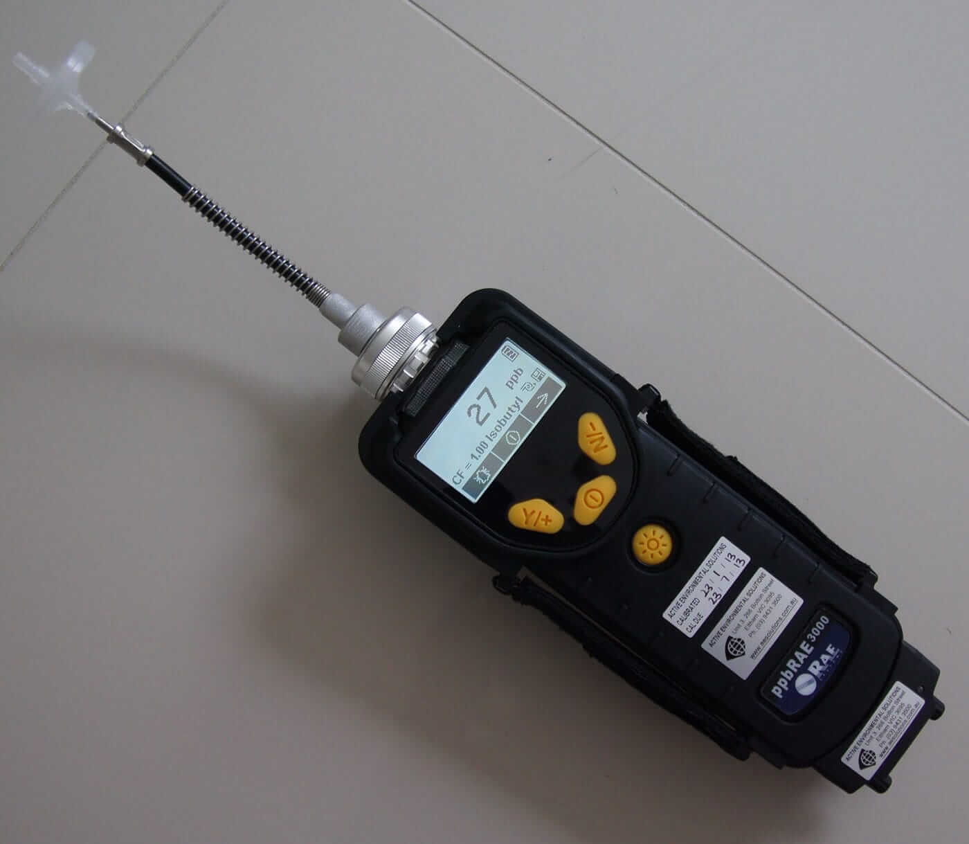 A small electronic device is sitting on a table, conducting air quality testing.